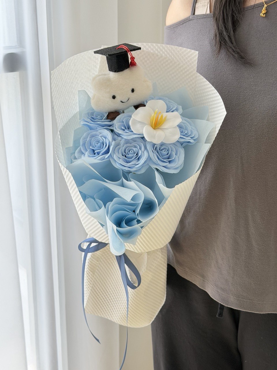Blue graduation soap flower bouquet featuring white tulip soap flower and cloud bear with graduation cap for university graduation in Sunway.