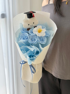Blue graduation soap flower bouquet featuring white tulip soap flower and cloud bear with graduation cap for university graduation in Sunway.