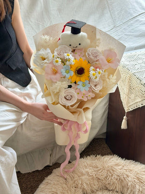 Premium sunflower soap flower bouquet with graduation cap teddy for university graduation gift at University Graduation event.