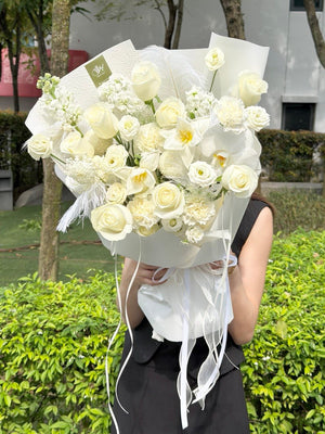 Clean white bouquet featuring phalaenopsis orchid, roses and tulips, modern luxury flower for anniversary or birthday same day KL delivery.