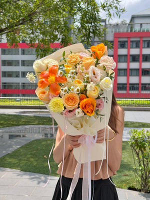 Premium orange tulip flower arrangement with white roses and pastel flowers for Mother's Day, anniversaries, and special occasions.