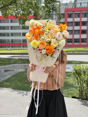 Same day flower delivery featuring an elegant orange tulip bouquet with pastel roses and seasonal blooms by Hug and Heart Florist Sunway Geo.