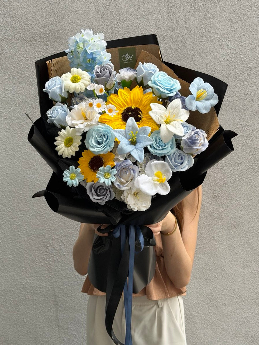 Sunflower soap flower graduation bouquet with blue roses and white daisies at Subang Jaya florist.