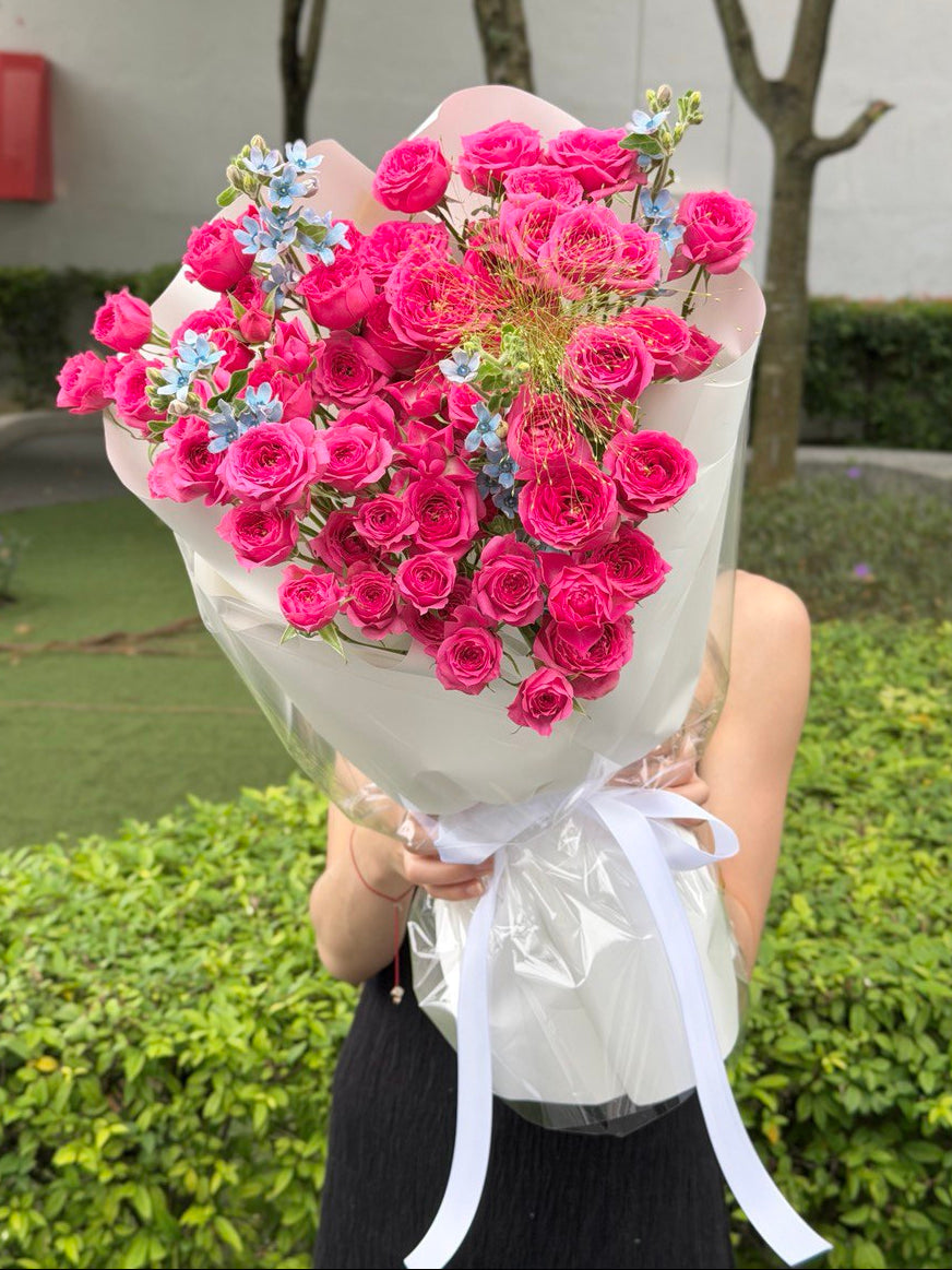 Sophie rose spray bouquet with vibrant pink spray roses and soft blue accents, wrapped elegantly for flower delivery by KL florist in Kuala Lumpur.