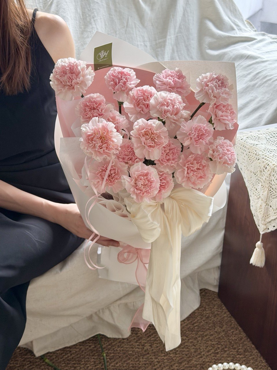 A bouquet of pink carnation with ribbon perfect gift idea for mother's day 2026.