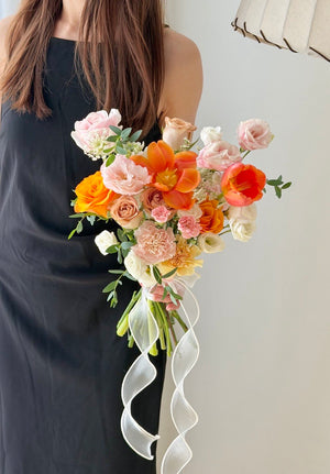 Modern wedding hand bouquet with vibrant orange tulips, blush roses and ivory flowers, ideal for ROM, wedding registration and brides.