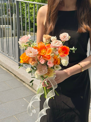 Premium orange tulip bridal bouquet featuring pink roses, soft pink flowers and fresh greenery for ROM and wedding ceremony.