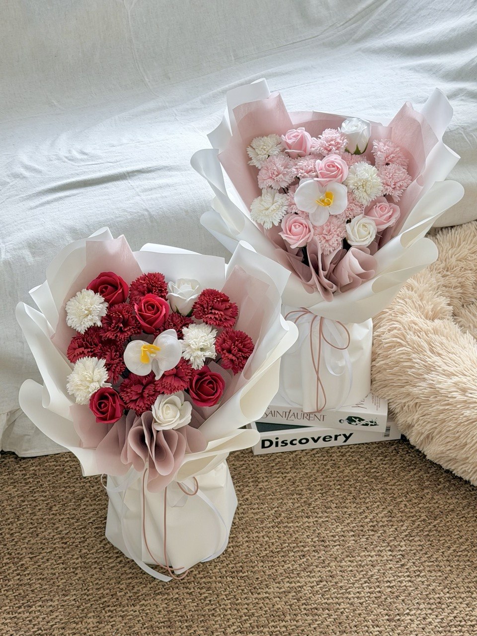 Two bouquets of soap flowers on a carpeted floor with a book in the background perfect for mother's day flower bouquet at Kuala Lumpur and Selangor.