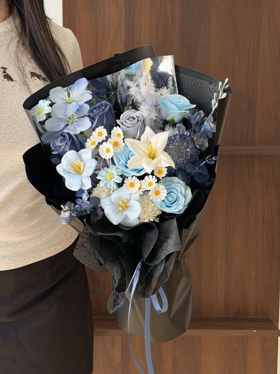 Luxury everlasting soap flower bouquet featuring blue roses, white lily, tulips, and elegant black wrapping, ideal for graduation, opening ceremony, and corporate gifting.