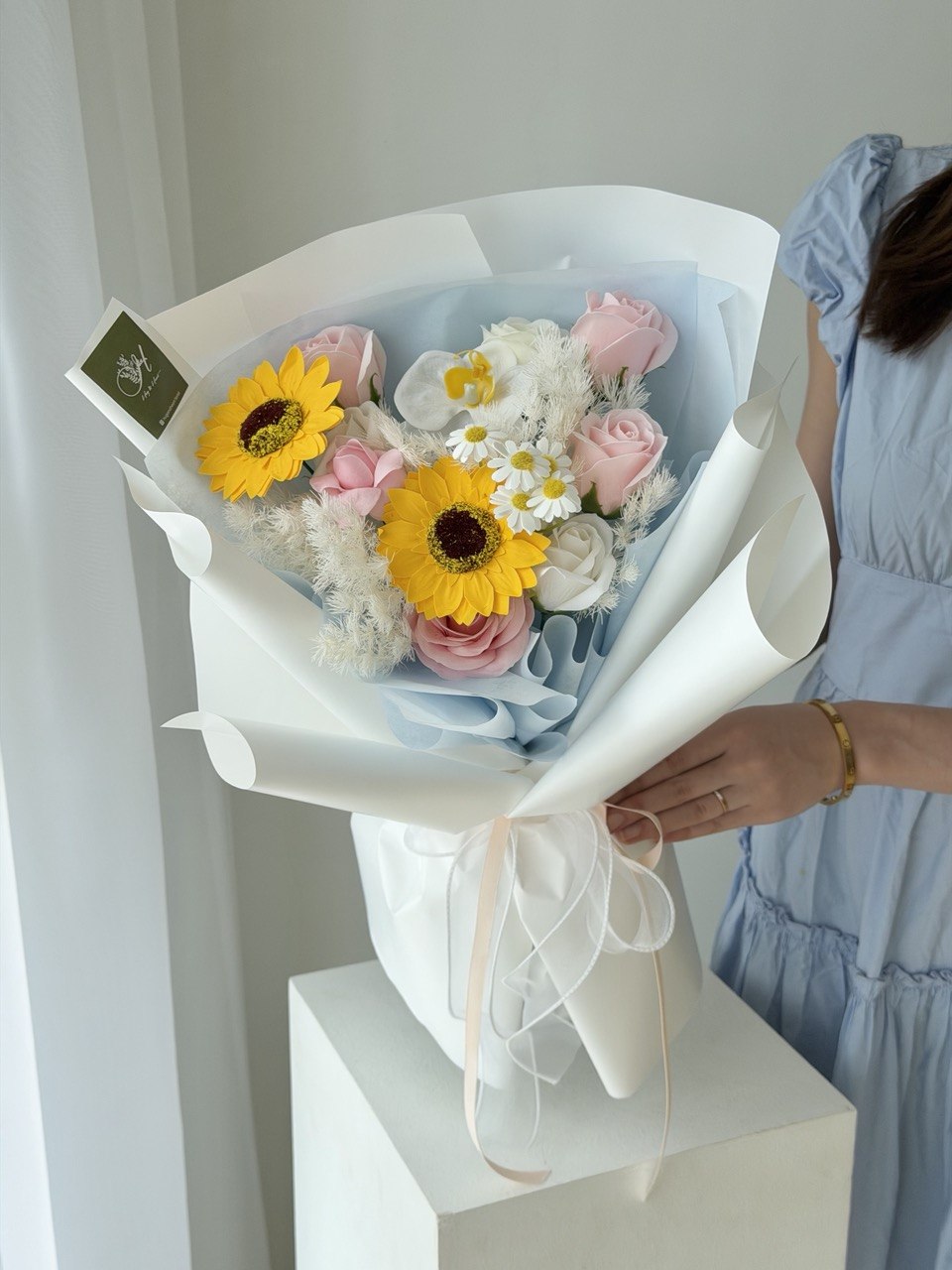 Graduation soap flower bouquet with sunflower, soft pink roses and elegant blue wrapping, same day flower delivery in Bukit Jalil.