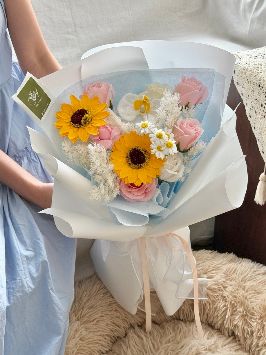 Soap flower bouquet with sunflower and pink roses in blue wrapping, perfect for university graduation, same day flower delivery Bukit Jalil.