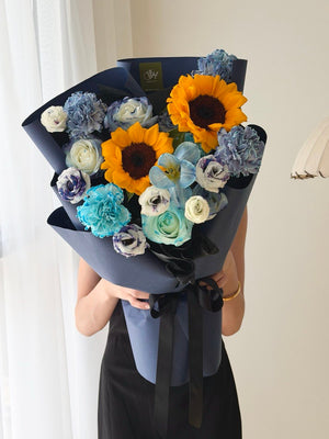 Sunflower bouquet with dyed blue tulips, roses and carnations in dark blue wrap, university graduation flowers Bukit Jalil same day delivery.