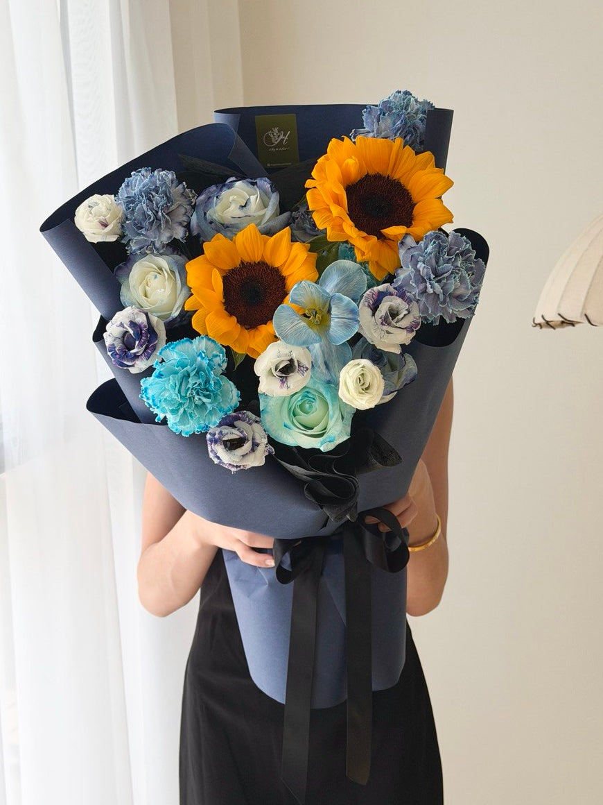 Sunflower bouquet with dyed blue tulips, roses and carnations in dark blue wrap, university graduation flowers Bukit Jalil same day delivery.