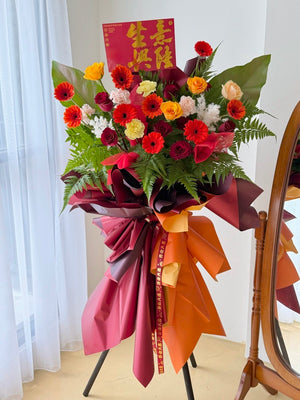 A red and orange theme grand opening flower stand with same day delivery business flower stand prepared by hug and heart florist subang jaya.
