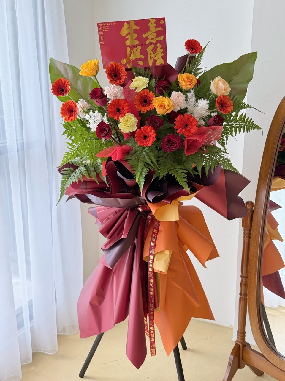 A red and orange theme grand opening flower stand with same day delivery business flower stand prepared by hug and heart florist subang jaya.