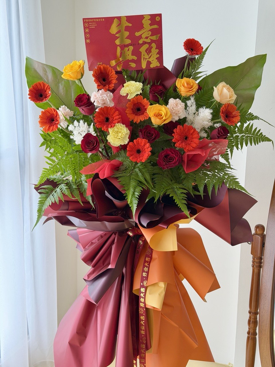 A red colour theme grand opening flower stand prepared by Hug and Heart Florist - perfect for business opening gift at Kuala Lumpur and Selangor.