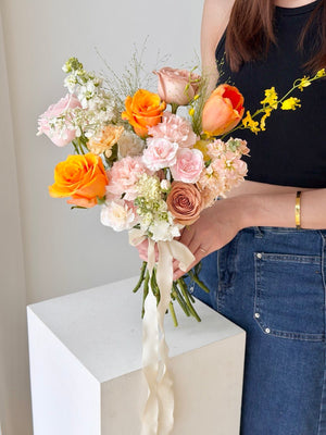 Soft pastel ROM bridal bouquet with orange roses, pink carnations and fresh flowers for wedding in Kuala Lumpur and Selangor.