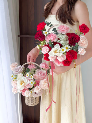 A girl is holding 2 basket of mother's day flower basket prepared by Hug and Heart Florist Sunway Geo.