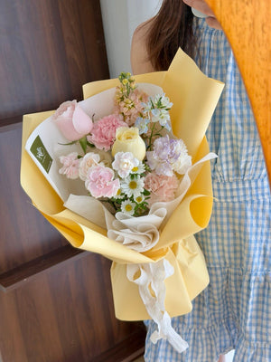 Elegant mini bouquet with pastel flowers and yellow wrap, suitable for birthdays, anniversaries and casual gifting.