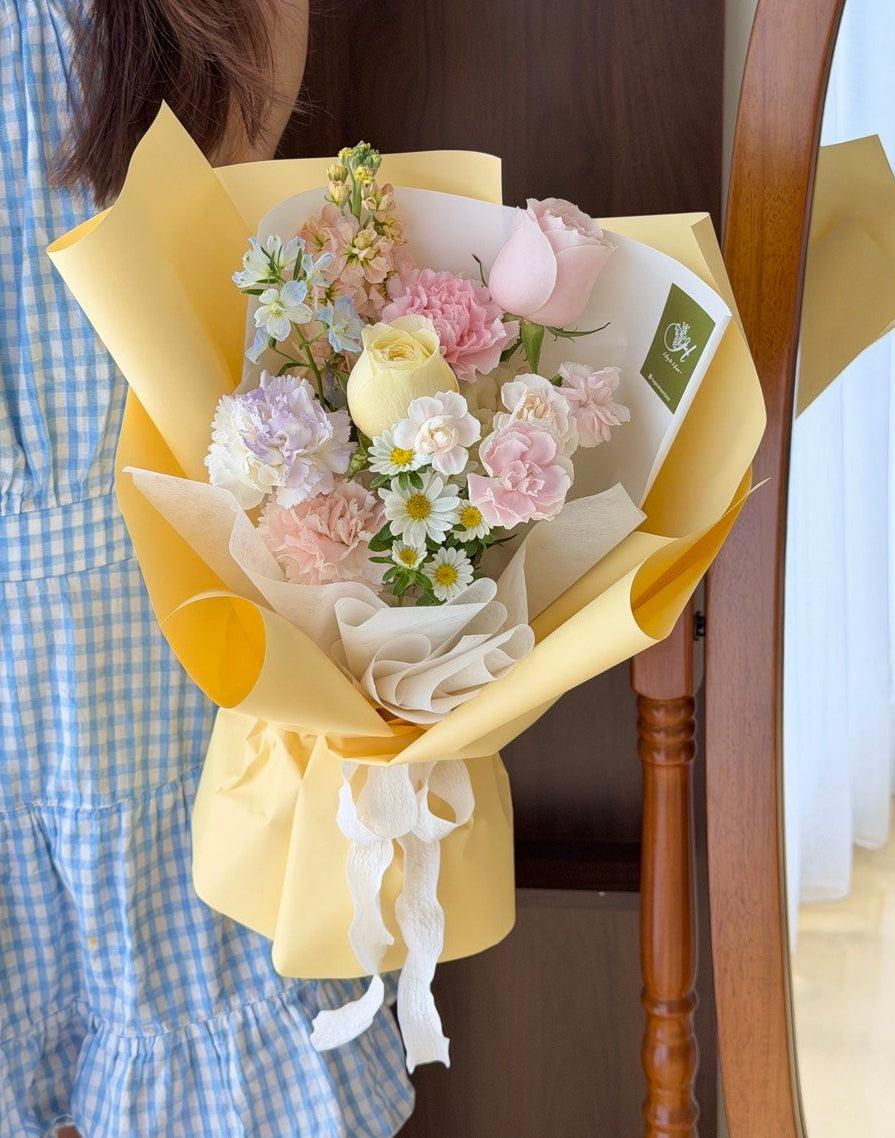 Small pastel flower bouquet in yellow wrapping, perfect for first date, birthday, anniversary or just because gift.