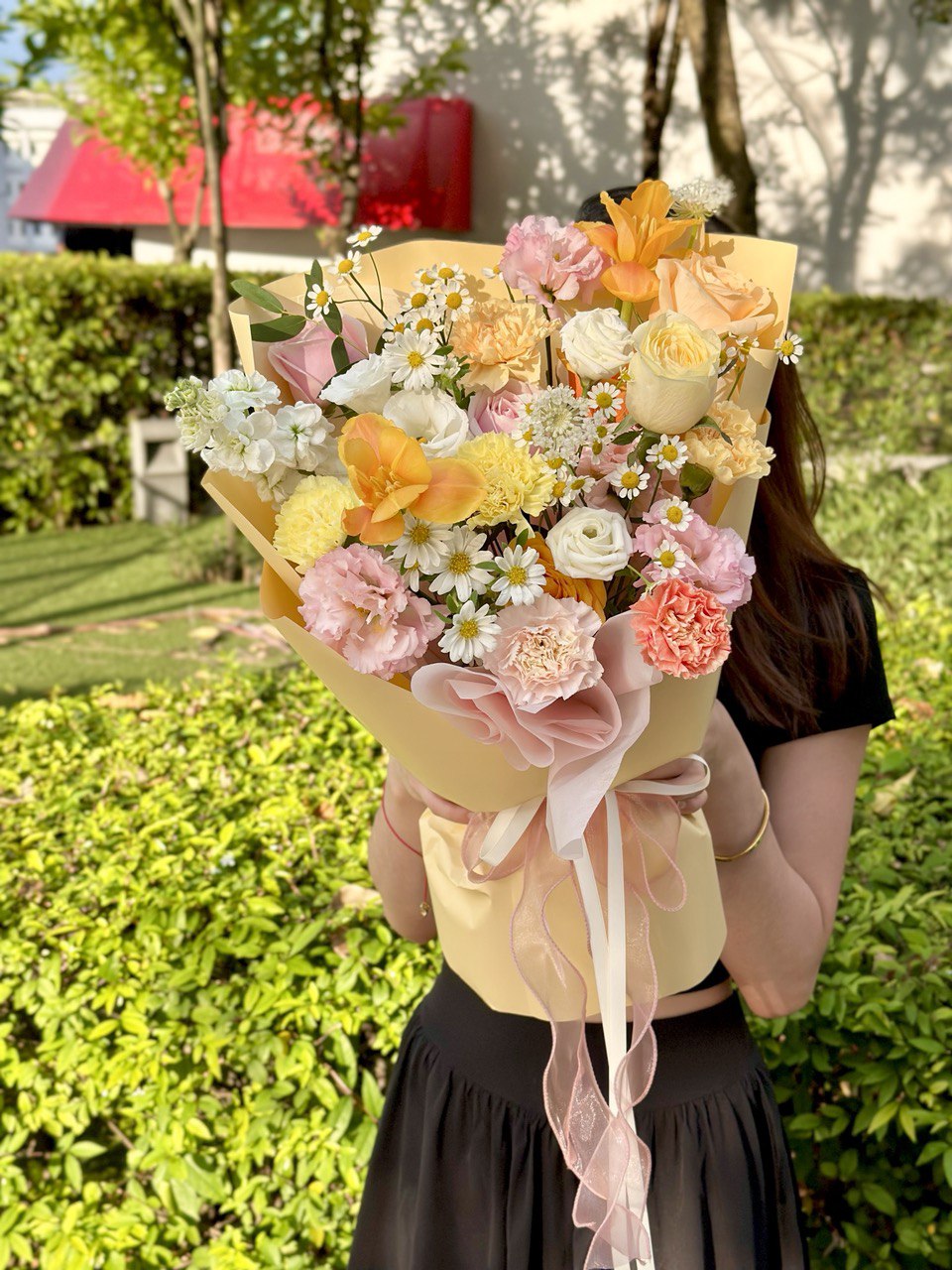 Colorful flower bouquet with daisy-like chamomile flowers and a variety of fresh seasonal florals.