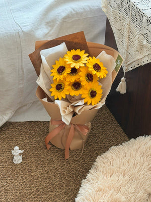 Bouquet of yellow soap sunflowers in a brown paper wrap perfect for sunway graduation.