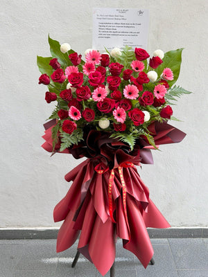 A red rose grand opening flower stand with pink gerbera perfect for Grand Opening gifting same day delivery available at Kuala Lumpur.