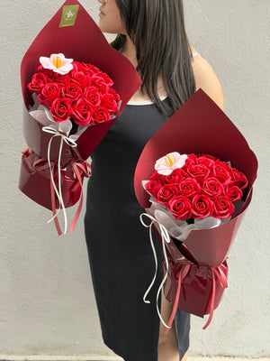 Romantic red rose soap flower bouquet with 20 stems and a peach tulip, designed by Hug and Heart Florist, same day delivery available in Kuala Lumpur Selangor.