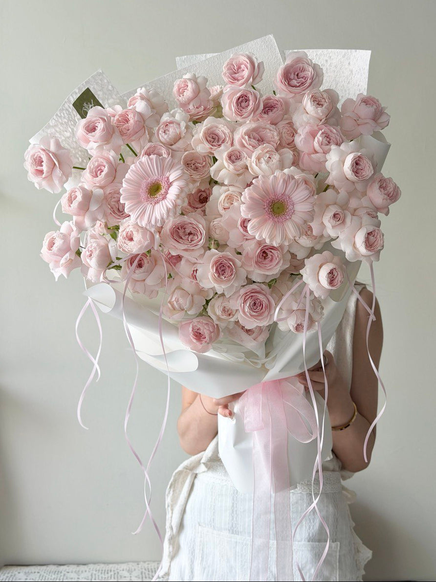 A bouquet of kiss of fairy rose spray mixed with pink gerbera prepared by Hug and Heart Florist at Kuala Lumpur.