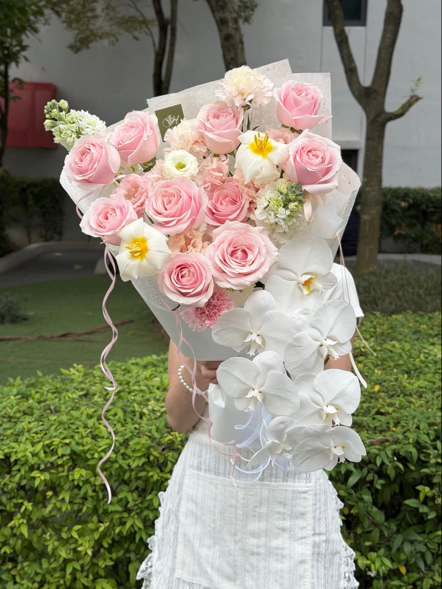 Luxury pink rose bouquet with cascading white phalaenopsis orchids and delicate tulips, perfect for anniversaries, Valentine’s Day, and same-day flower delivery.