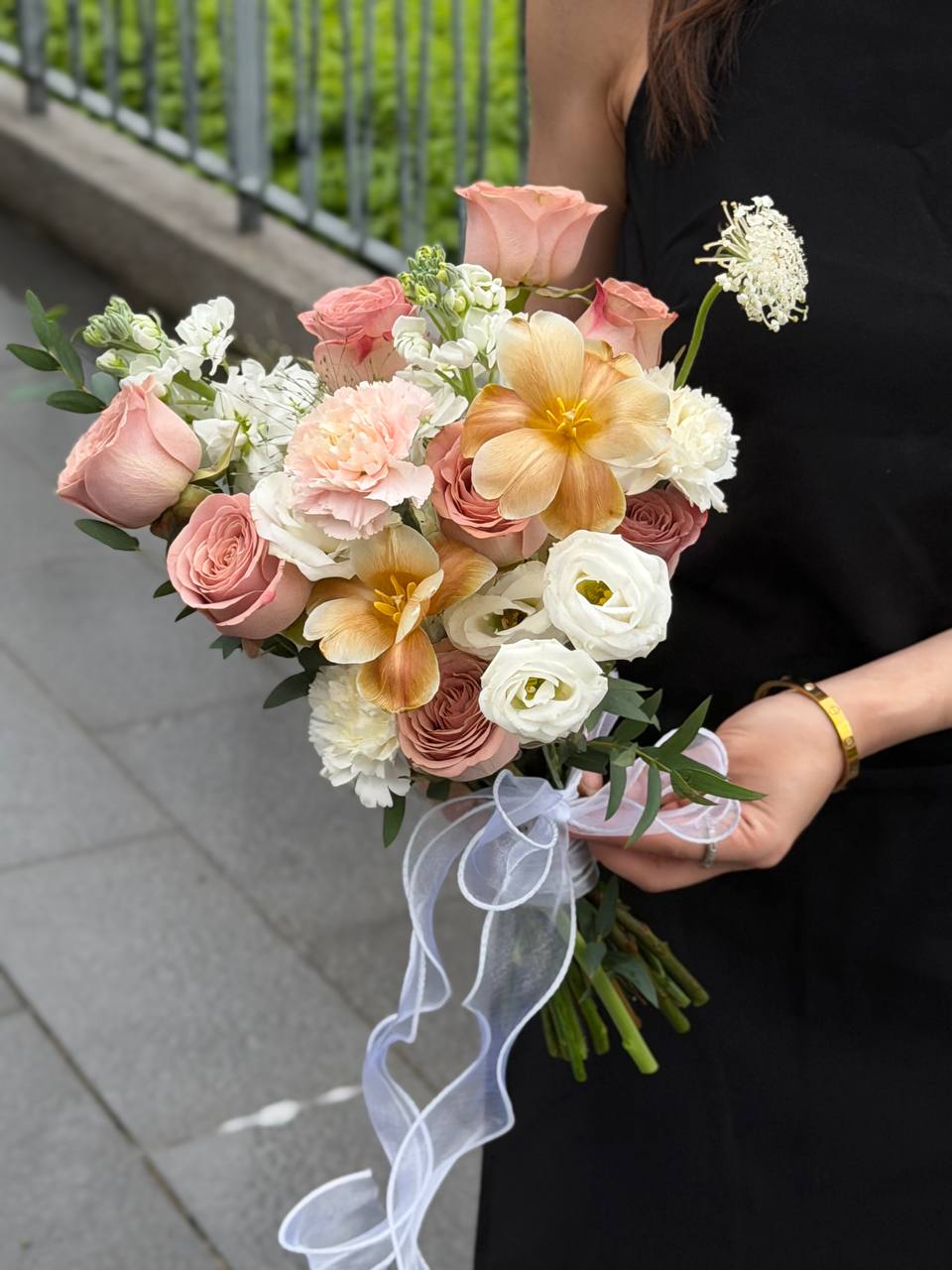 A bouquet of cappuccino ROM flower held by a girl wearing black dress at Malaysia.